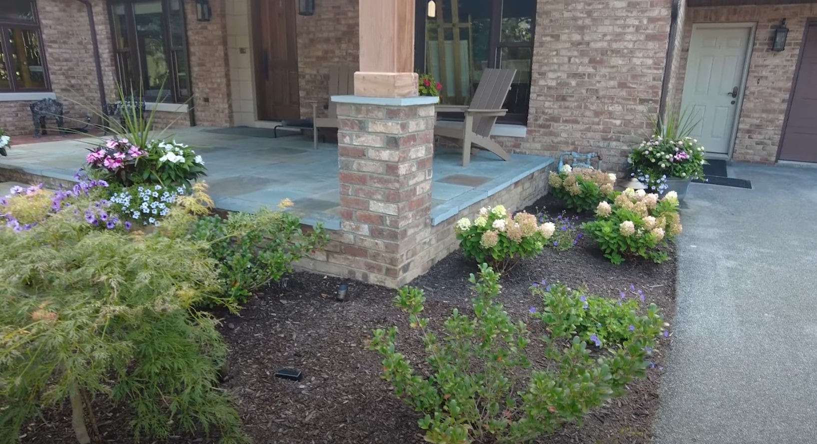 Modern patio hardscaping with integrated planters and professional landscape lighting